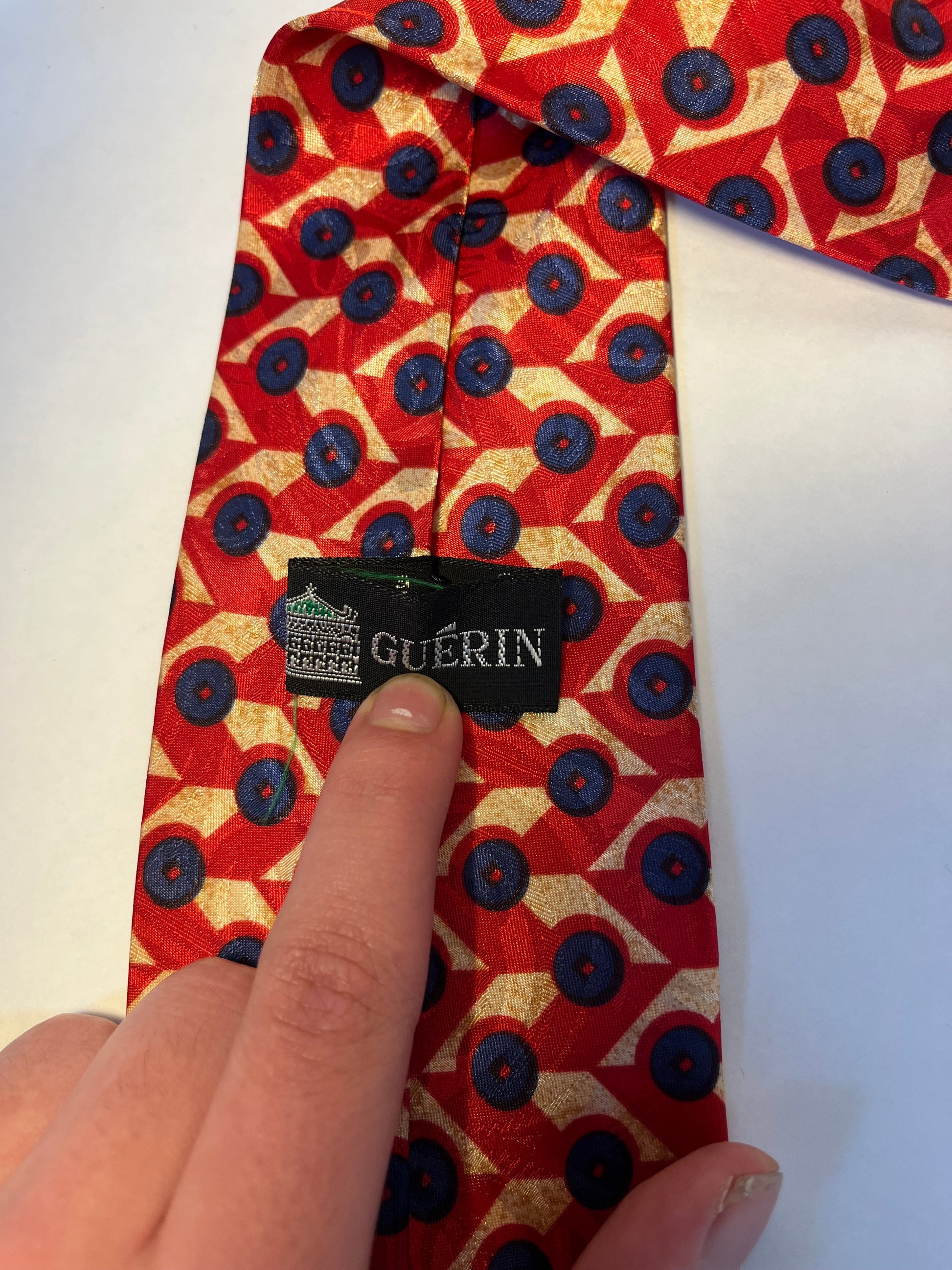 Red blue and tan patterned tie